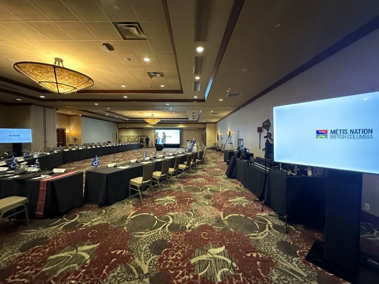 Conference boardroom set for a Métis Nation BC meeting — table microphones for every delegate and a large LED screen driven by Valley Tech