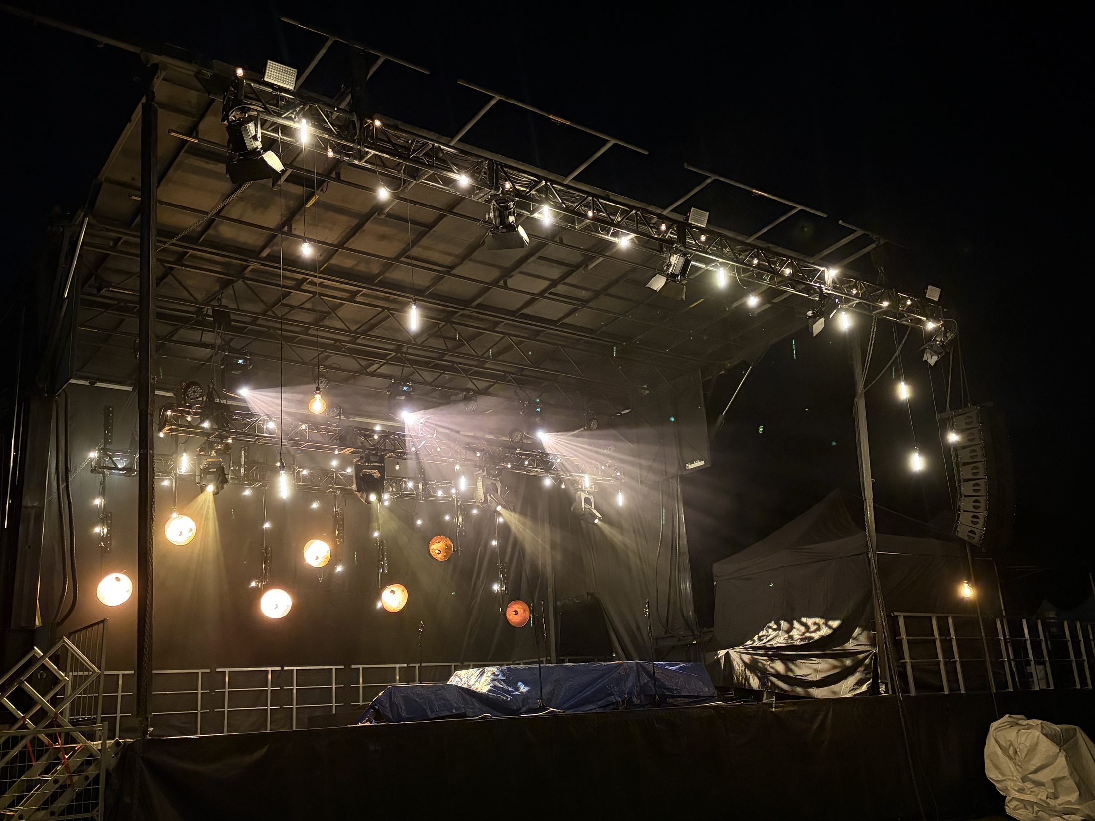 Valley Tech outdoor mobile stage lit at night with a full roof truss, hanging lighting and line-array sound rigging at a Lower Mainland event
